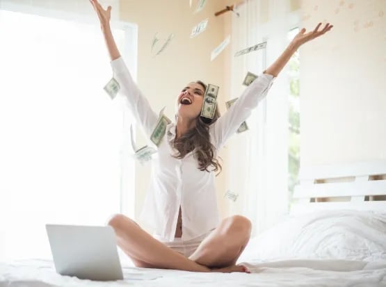 woman-with-dollar-bank-note-on-the-bed
